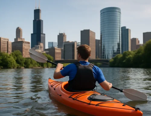 Person kayaking in an orange kayak on calm waters with a view of Chicago's skyline, emphasizing beginner-friendly kayaking experiences near the city.