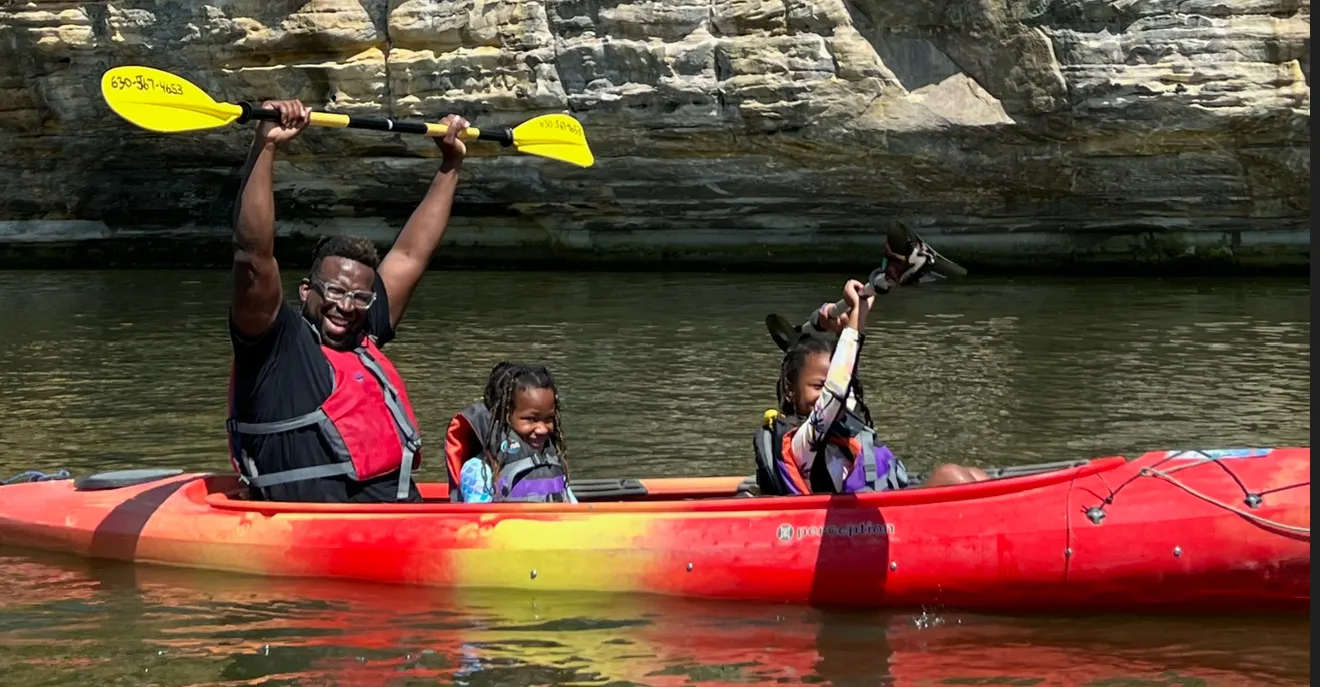 Kayakers on the Illinois River at Starved Rock State Park surrounded by nature